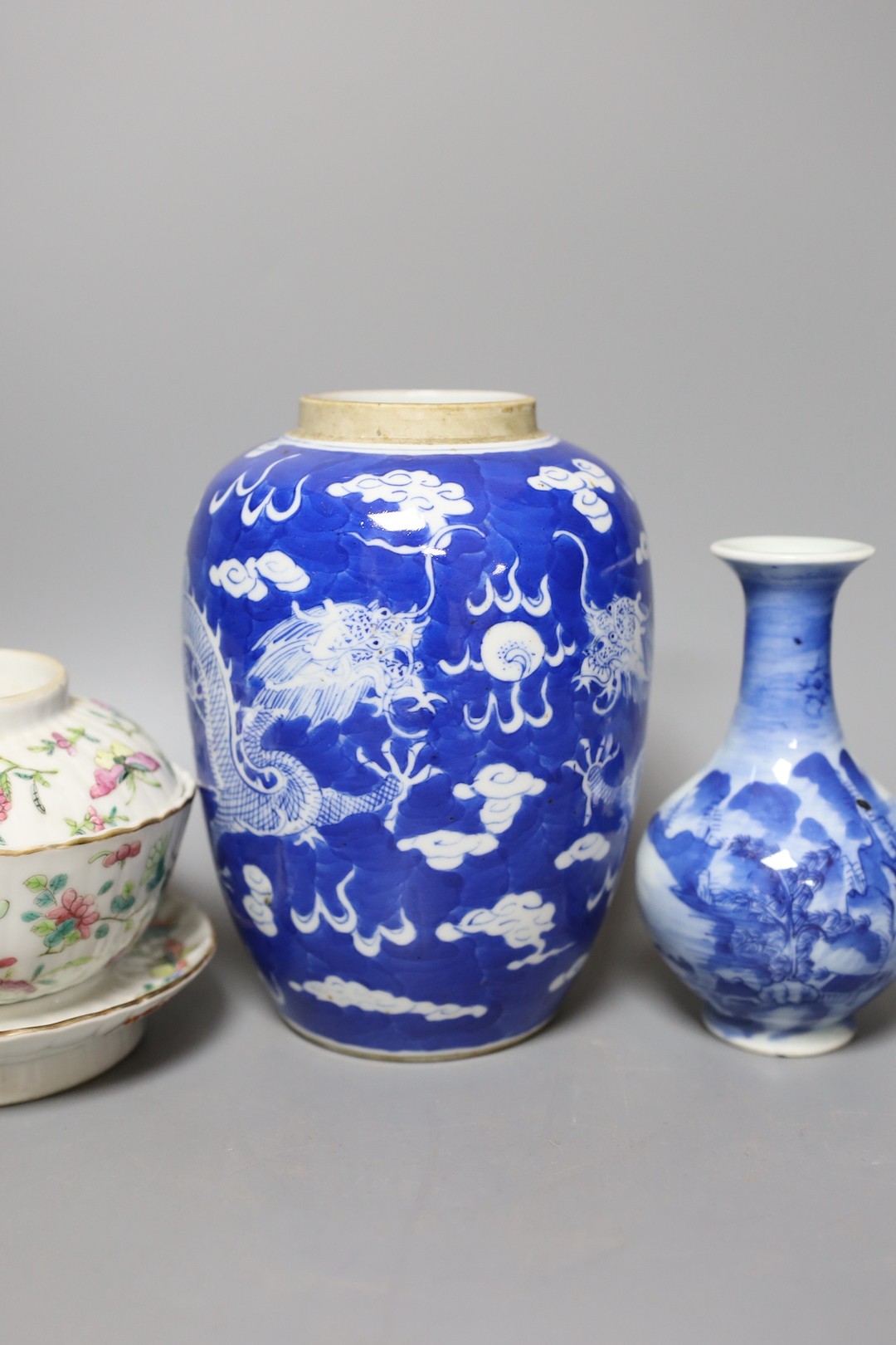 A 19th century Chinese famille rose rice bowl, cover and stand, together with a blue and white dragon jar and similar bottle vase. Largest 18cm